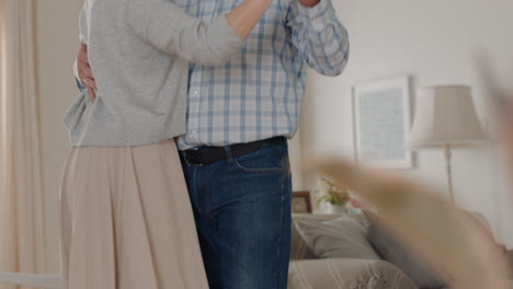 happy mature couple dancing at home enjoying romantic dance together celebrating relationship milestone having peaceful retirement 4k