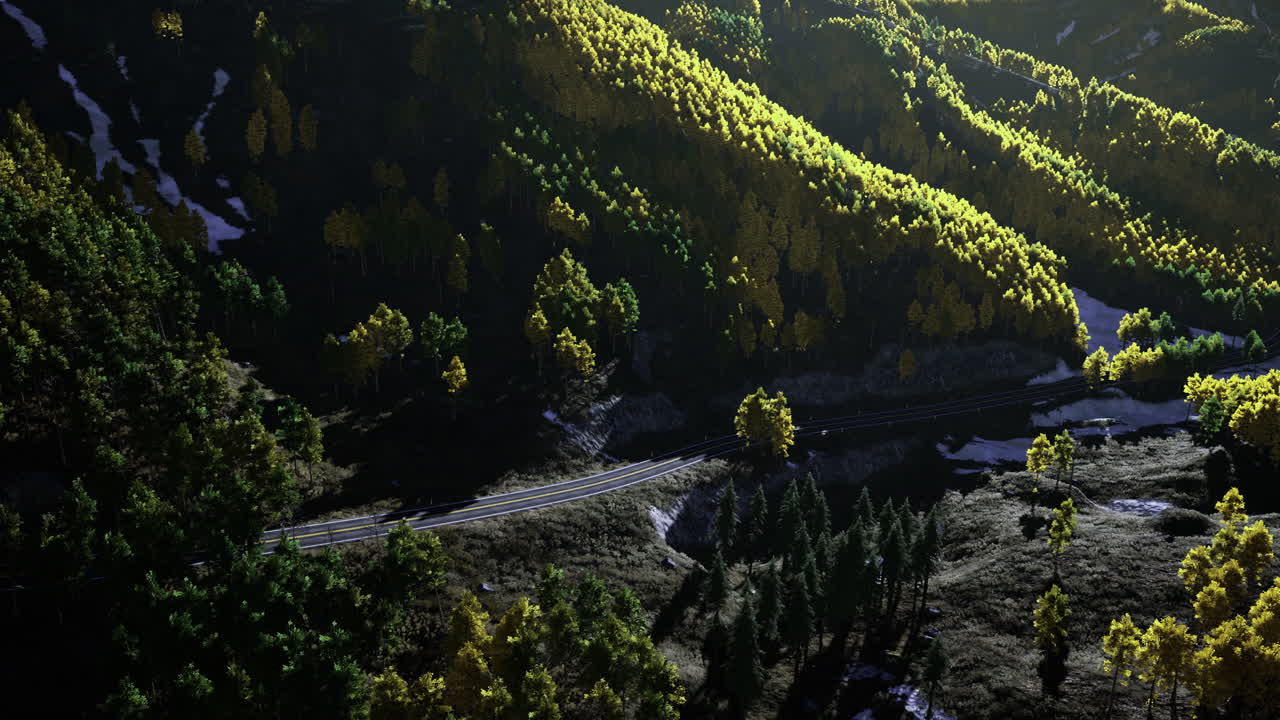 Daylight view of rolling hills vibrant trees and a winding road
