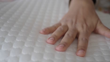 hand on a white memory foam pillow