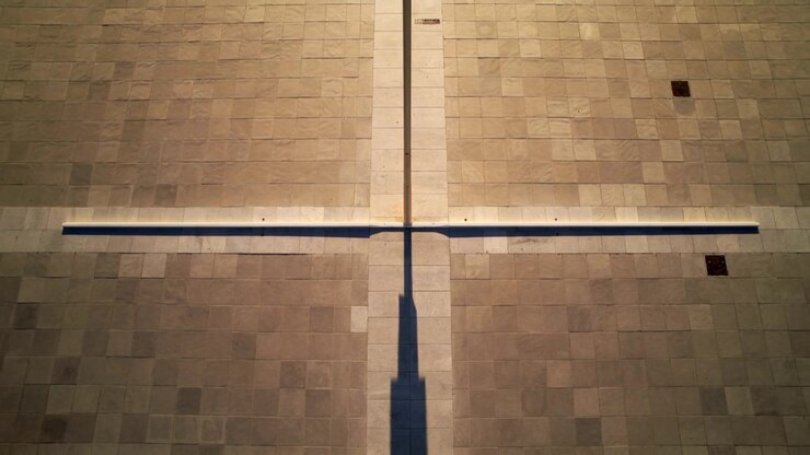 Throwing ledge and vertical strip casting shadow across roof tiles as sun moving, showing vents