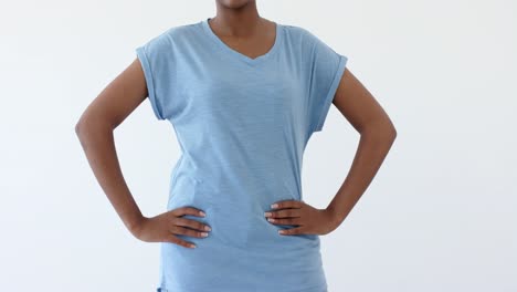 Midsection-of-african-american-woman-wearing-blue-t-shirt-with-copy-space-on-white-background