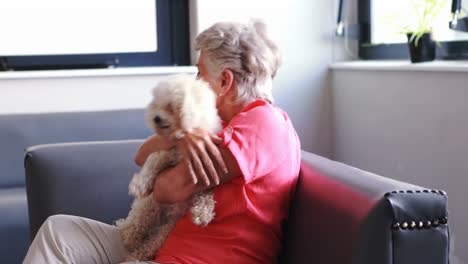senior woman pampering dog