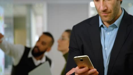 animation of social media likes notification over caucasian businessman using smartphone at office
