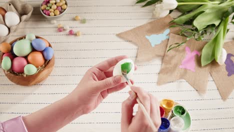 happy easter holiday. coloring eggs top view. woman preparing for easter, painting and decorating eggs. christian celebration, family traditions.