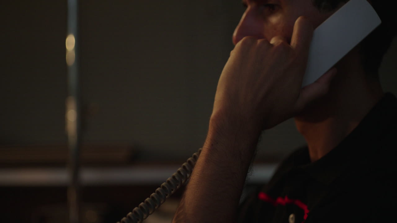 Person working at a desk with a laptop and phone