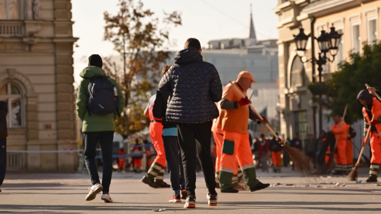 Street sweeper cleaning Town hall building and square after protest over fatal rail