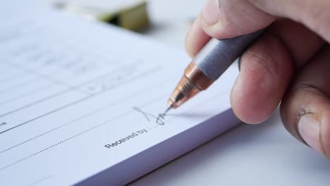 close up of signature on a contact on table ,