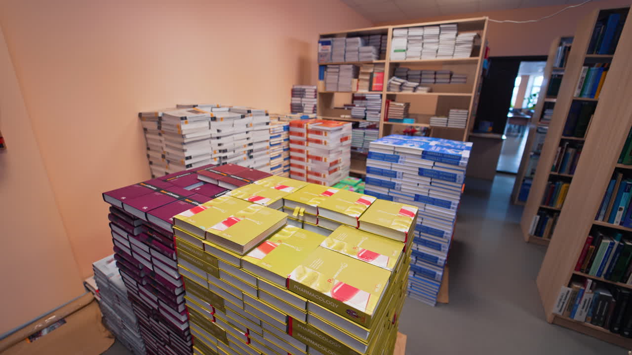 Shot inside the university library. View of books organized in shelves in big medical university