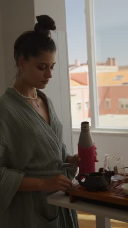 woman preparing tea in kitchen