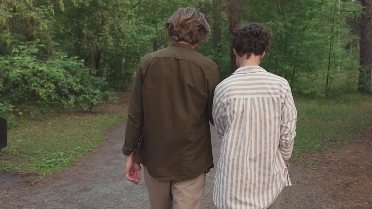 Couple Walking In Forest In Summer