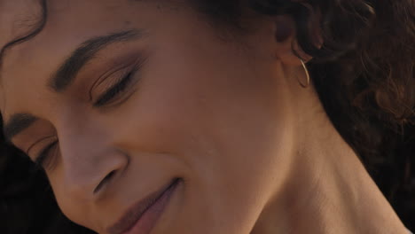 close up portrait of beautiful happy woman enjoying freedom exploring spirituality feeling hope on peaceful seaside at sunset with wind blowing hair