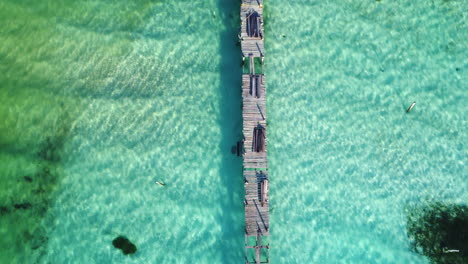 Aerial-drone-shot-of-broken-wooden-pier-mexico-Bacalar---Aerial-view-above-a-wooden-pier-at-the-Bacalar-lagoon,-in-Mexico---birds-eye,-drone-shot