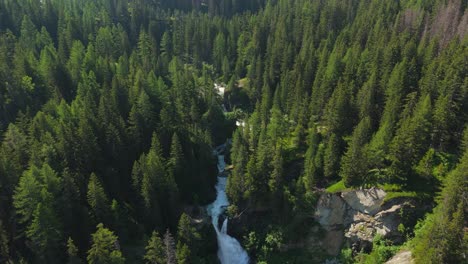 a stunning waterfall cascades through lush greenery in the italian alps