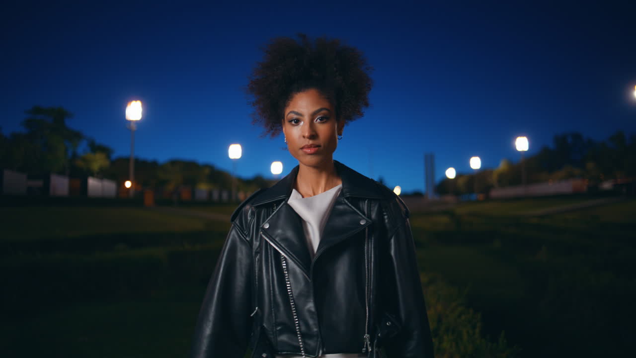 Woman standing night sky looking camera confidently closeup. lady street