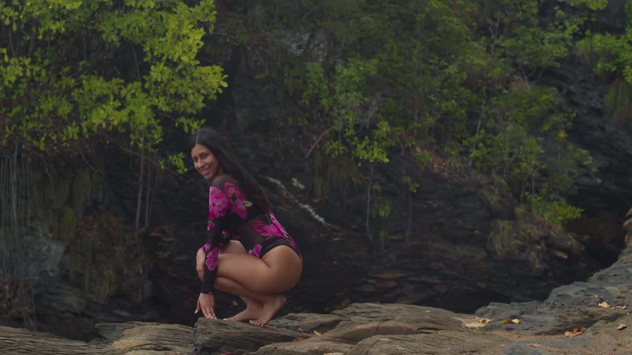 A cliffside beach in the Caribbean showcases a Latin girl in delicate lingerie.