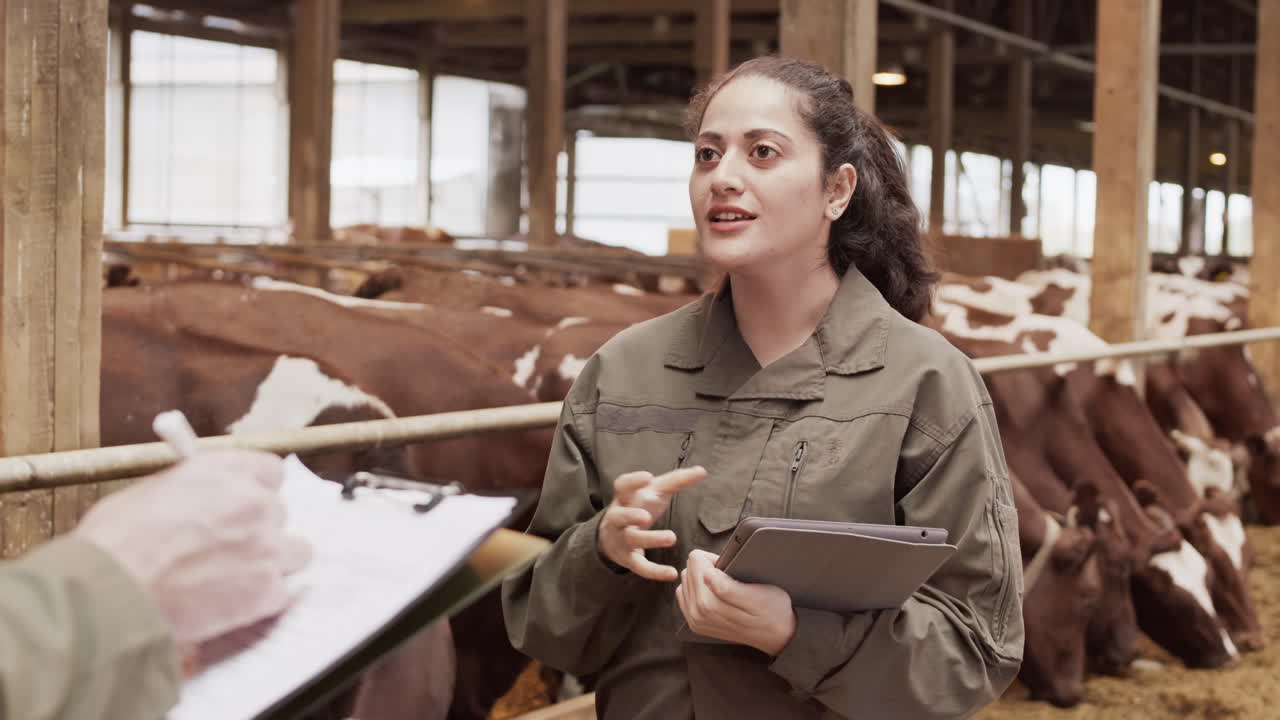 Female Farmer Talking to Unrecognizable Colleague