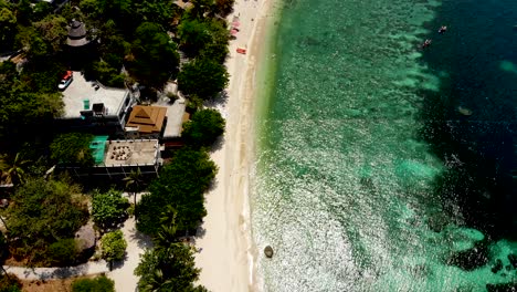 a overhead aerial drone shot panning from bottom to the top, revealing the tip of the peninsula of sai daeng private beach resort in koh tao island in surat thani province in thailand