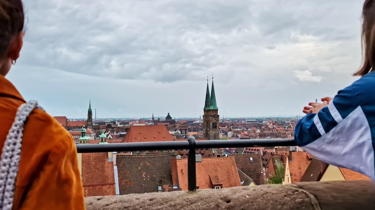 Two women enjoying panoramic city view from Nurnberg Imperial Castle