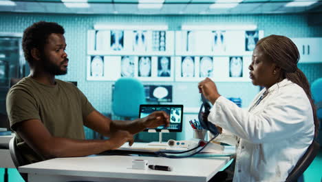 black medic measuring the blood pressure and pulse of a male patient