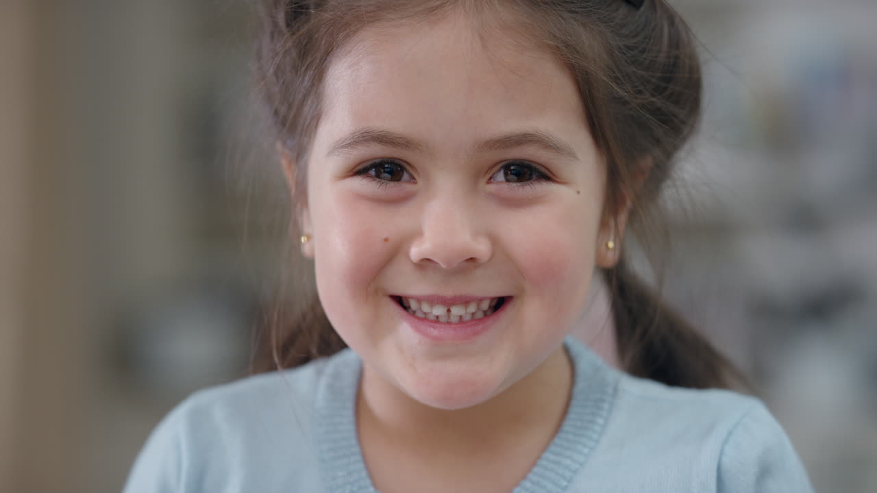 portrait beautiful little girl smiling looking at camera cute child with playful expression enjoying happy childhood 4k