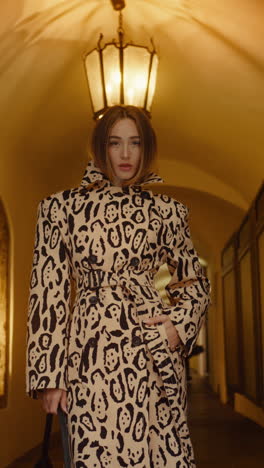 stylish woman in leopard print trench coat
