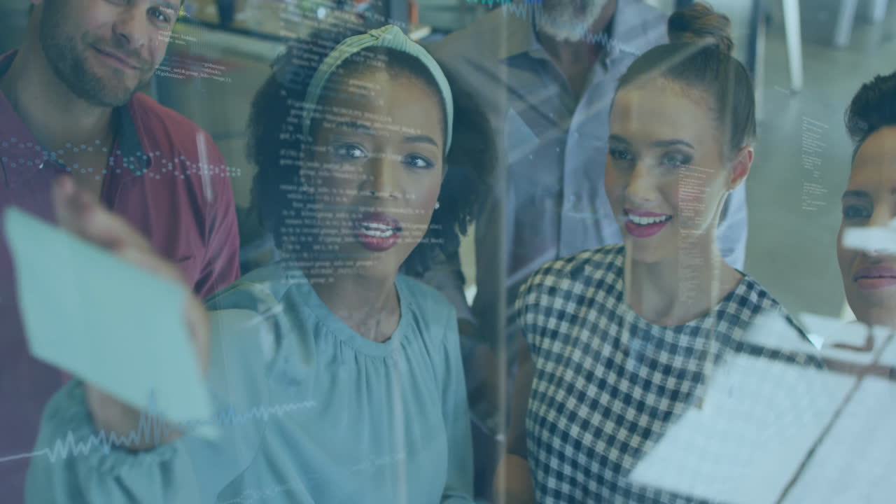 In office, diverse team analyzing data on transparent screen, discussing animation