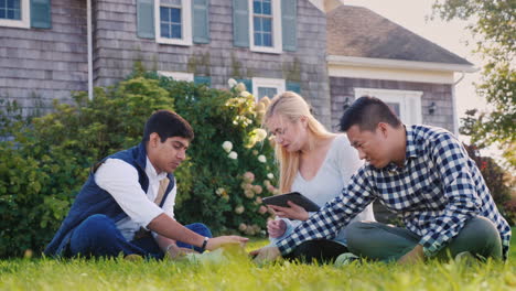 Friends-Relaxing-With-Puppy-and-Tablet-in-Yard