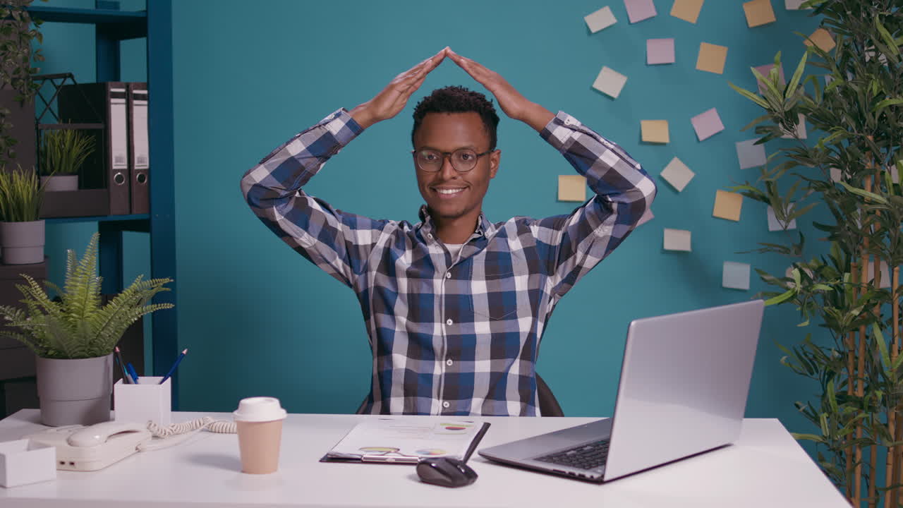 Company employee doing house roof gesture with arms