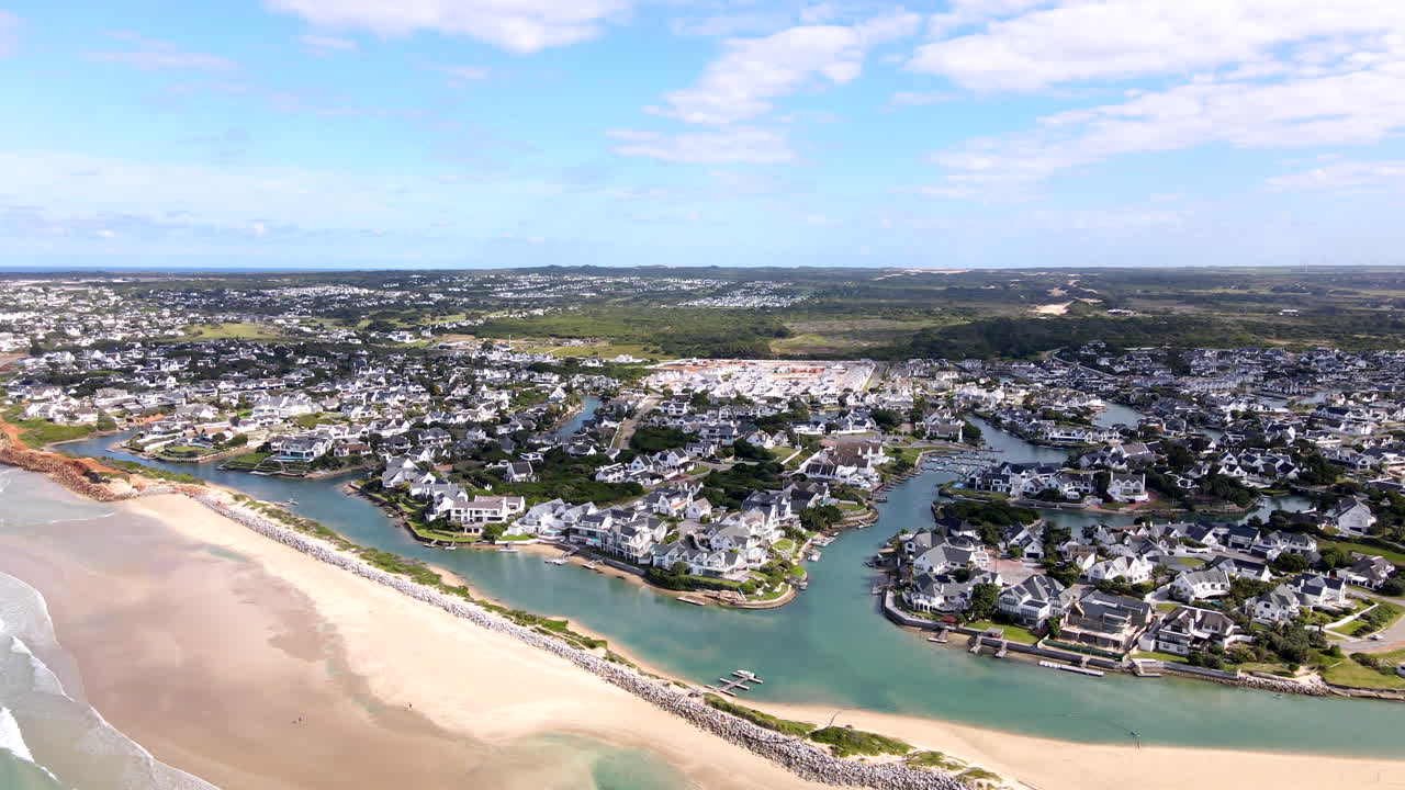 Breakwater on St Francis Bay beach protects canal-side properties. Aerial view