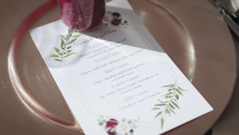 gold plate and menu place setting for a dinner at a wedding venue