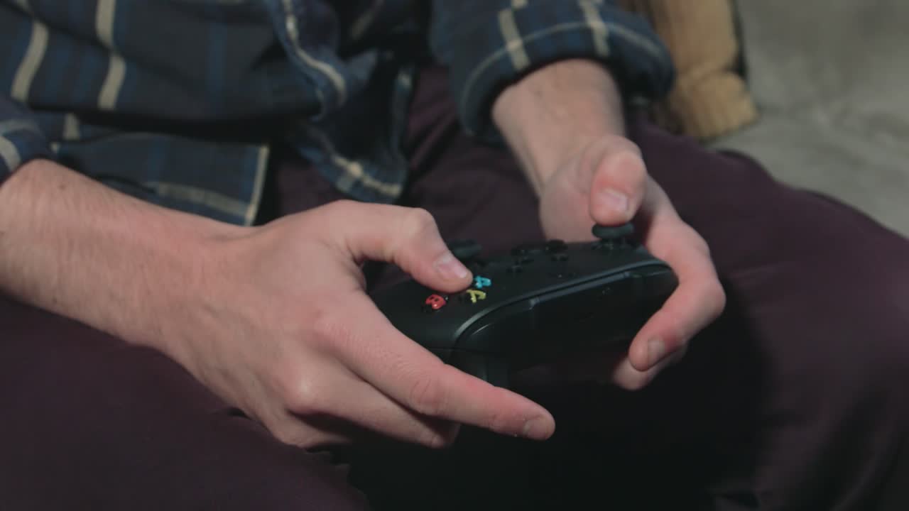 Hands Using Video Game Controller - Medium Close Up