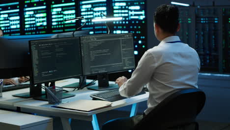 it employee at work doing maintenance on server room hardware