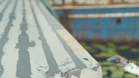 Close-shallow-depth-of-field-flattening-out-sika-flex-wooden-boat-cabin-roof-planking