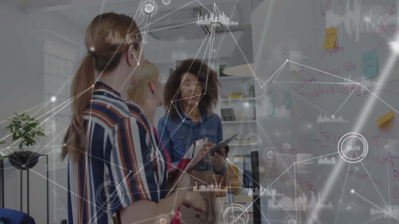 Diverse team collaborating on whiteboard with data processing animation overlay