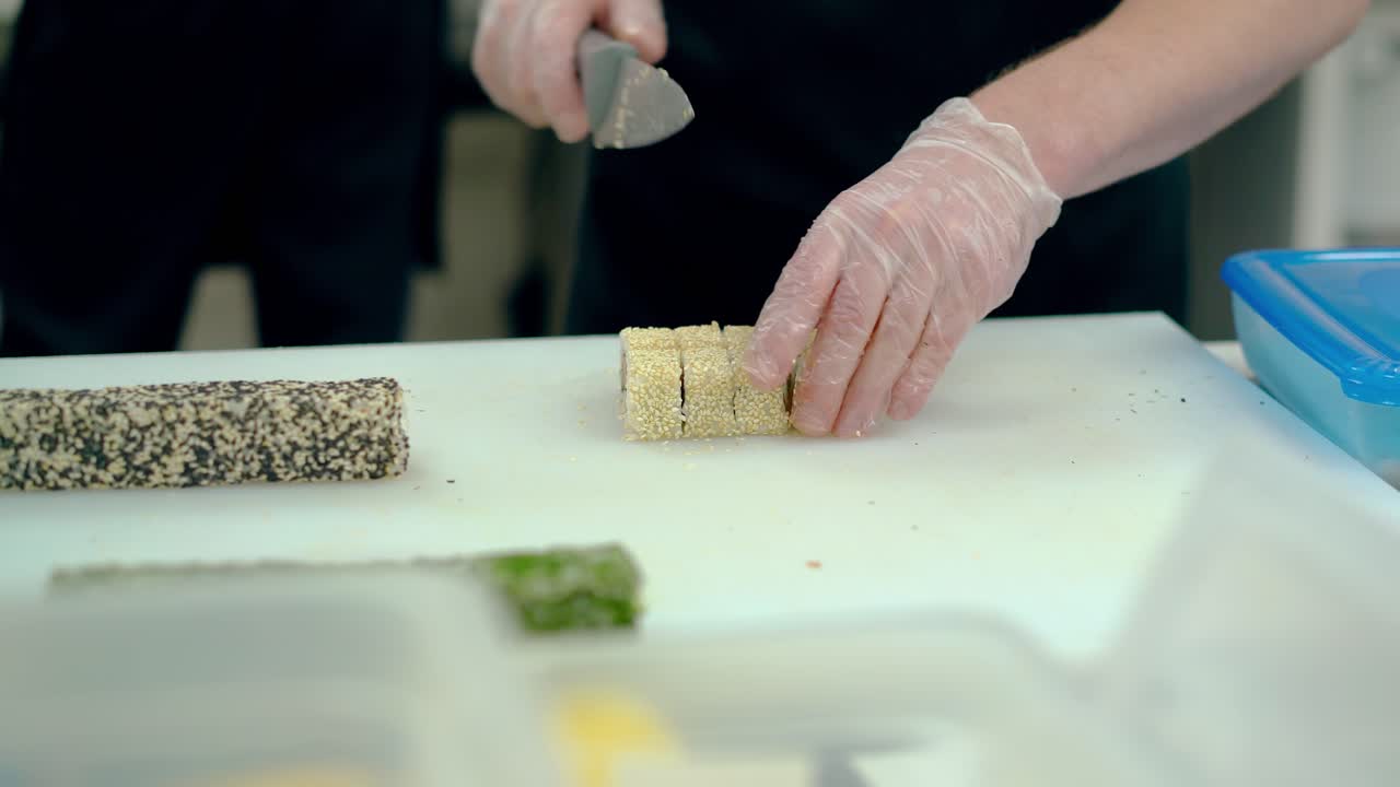 요리사는  ⁇  세자미로 일본 롤을 잘라줍니다.