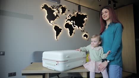 woman caring for baby by suitcase symbolizing new beginnings a heartwarming video of a woman holding a baby with love next to a suitcase symbolizing a journey or new beginnings capturing a tender moment between them
