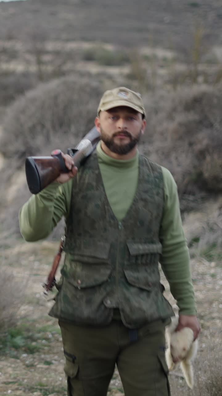 Hunter with rifle in the wilderness