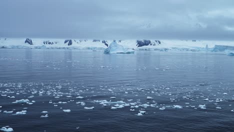 Global-Warming-and-Climate-Change-in-Antarctica-with-Mountains-and-Icebergs-Landscape-Scenery,-Ocean-and-Sea-Water-in-Beautiful-Dramatic-Amazing-Antarctic-Peninsula-Winter-Scene