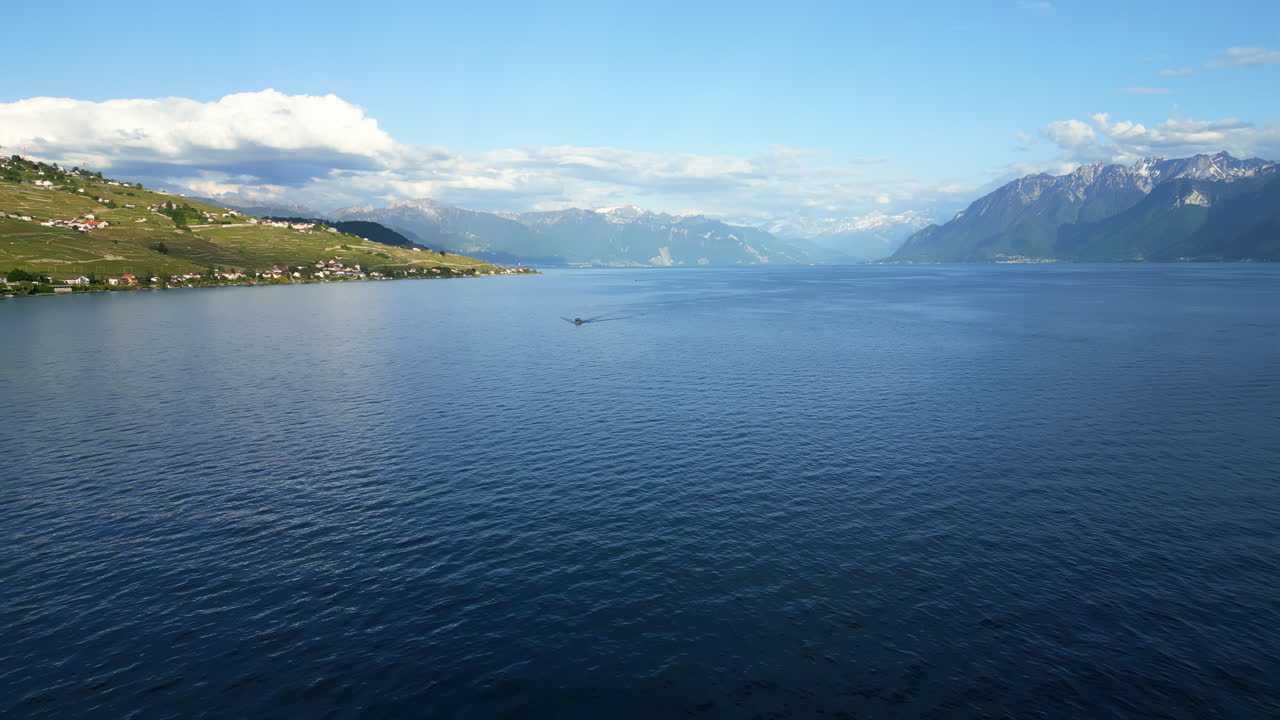 Aerial: Lavaux terraced vineyards and Lake Geneva during the day in canton of Vaud, Switzerland, establishing drone shot