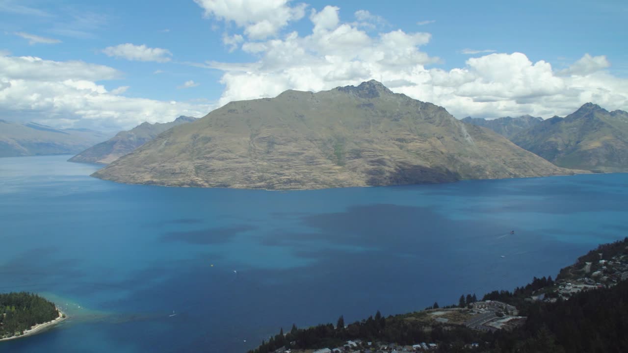 Panning shot showing all of the immensely beautiful Queenstown and the alps in New Zealand