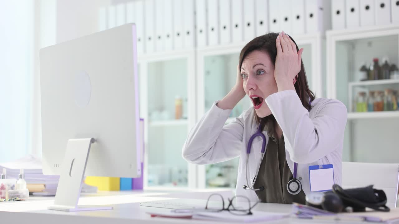Shocked Female Doctor Reacts to Computer Screen in Medical Office