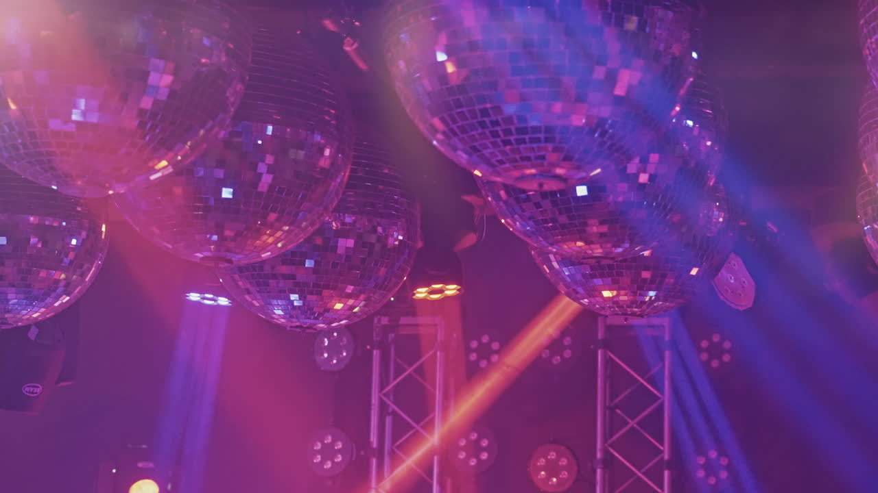 Bolas de Discoteca Brilhantes Refletindo Luzes Dinâmicas em uma Boate