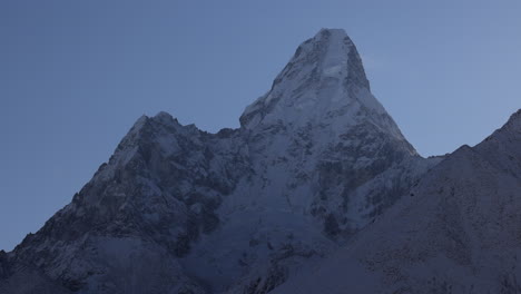 upward pan of ama dablam mountain at sunrise in nepal.