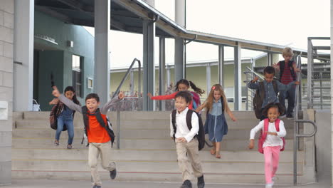 a group of energetic elementary school kids leaving school