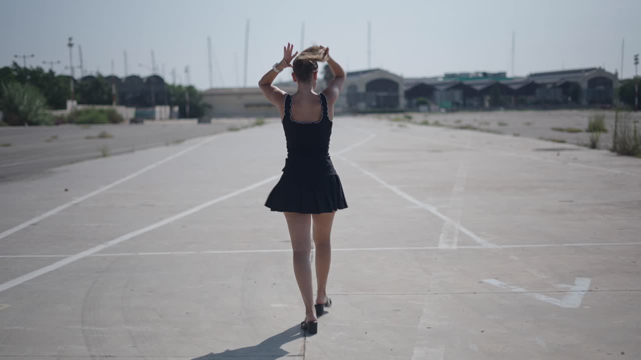 Woman walking on an empty parking lot