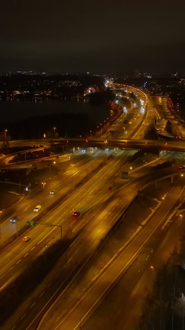 Vertical drone shot of traffic on route 51 Lansivayla, night in Espoo, Finland