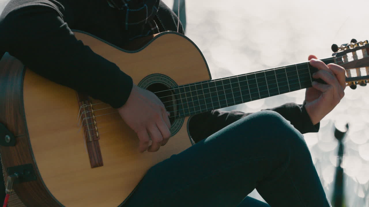Close-up of musician playing acoustic guitar in Argentine folk music performance