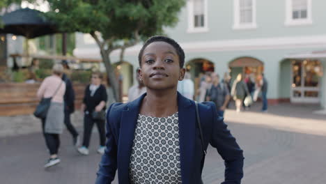 slow-motion-portrait-of-stylish-african-american-woman-looking-confident-smiling-at-camera-in-city-enjoying-urban-evening