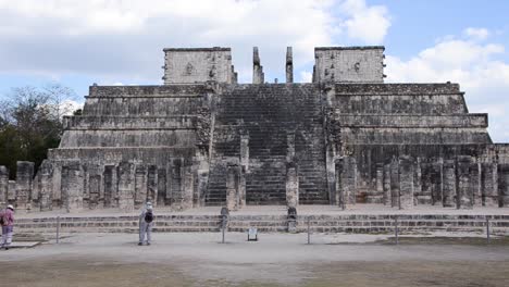 tourists visiting temple of a thousand warriors in the chichen itza archaeological site.