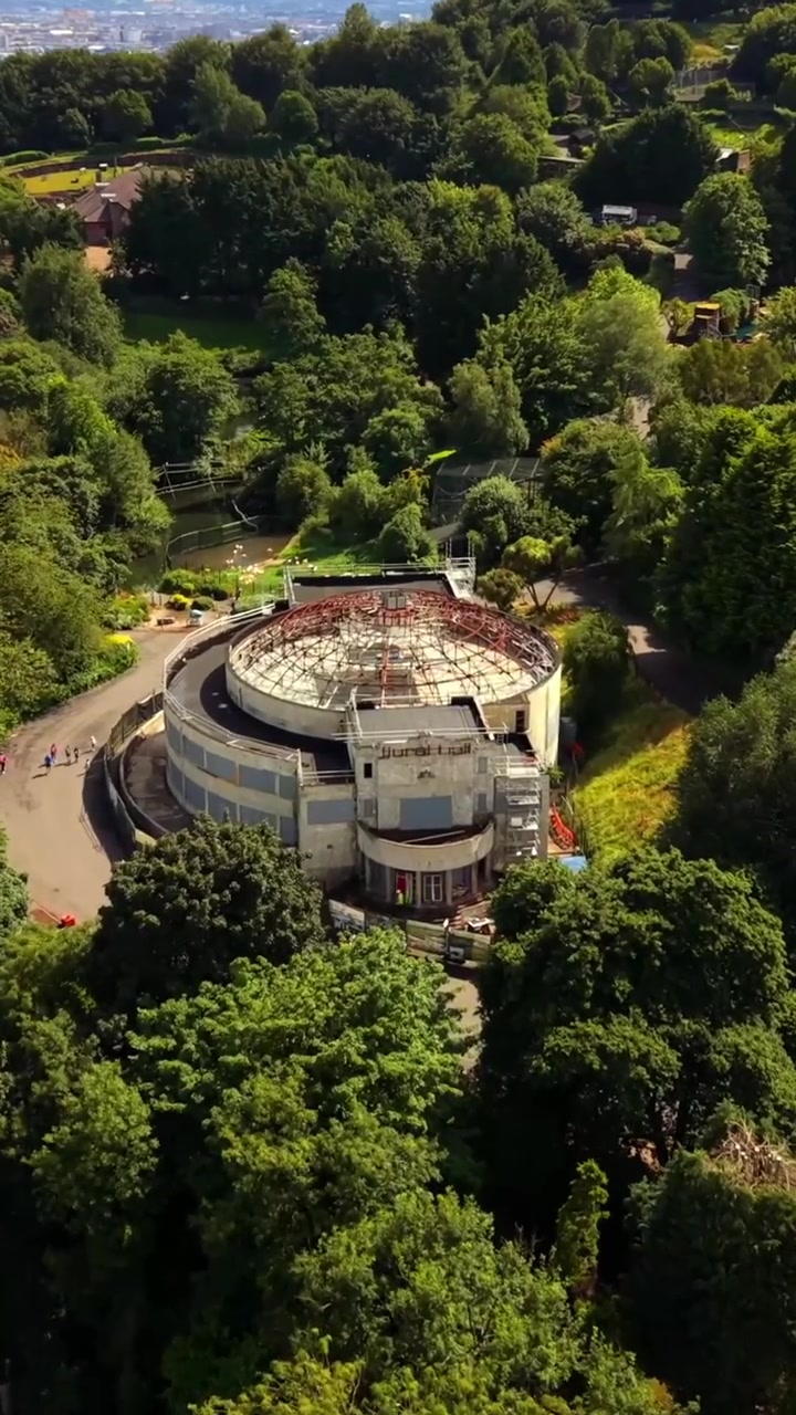 Descending 60FPS vertical social ratio aerial video of Belfast Zoo and Cavehill in North Belfast, Northern Ireland in the UK on a bright sunny day. Produced with Rec709 colour.